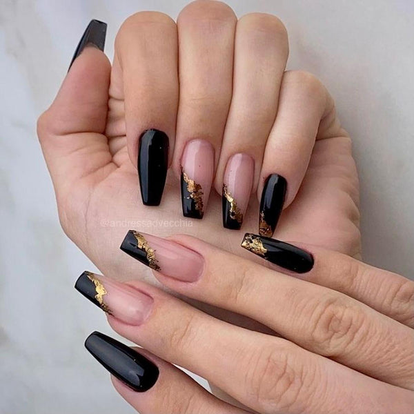 someone's hands with black nail design and gold foil black manicure acrylic nails swirls post ideas cow print long nails black nails black nail design glitter tip black nail designs silver glitter nail design black nails nail design black nail design