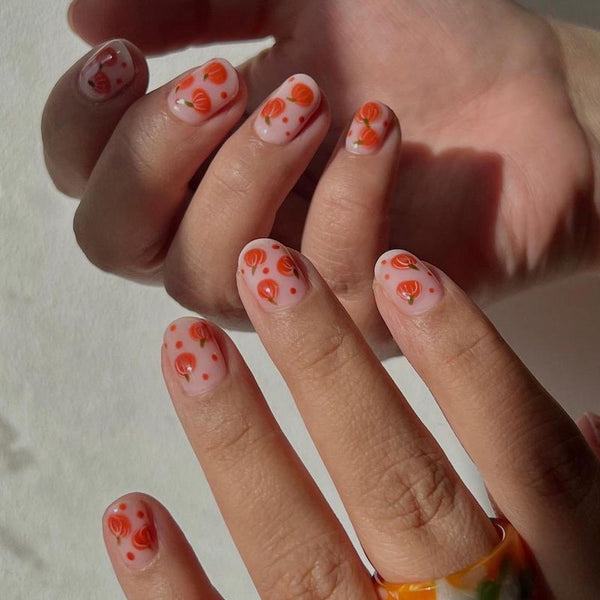 someone's hands with nail art with pumpkins pumpkin nail design pumpkin nail art fall ideas pumpkin nail design pumpkin design plaid white image love nails halloween nails pumpkins halloween nails