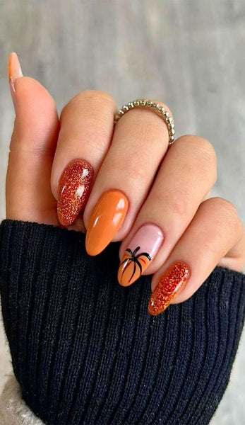 someone's nails with glitter and pumpkin nail designs matte pumpkin nail design classic cute dark fun pumpkin nail design ideas fall fall ideas fall colors dark fall pumpkin nails pumpkins nails