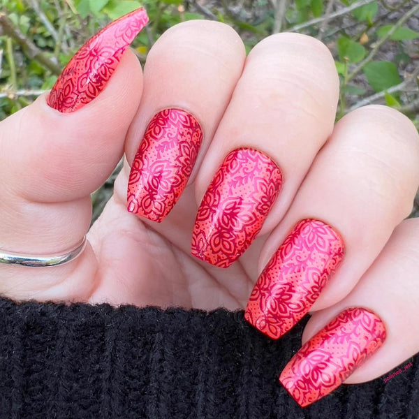 someone's nails with red floral nail art dotting tool petal shapes nail glue