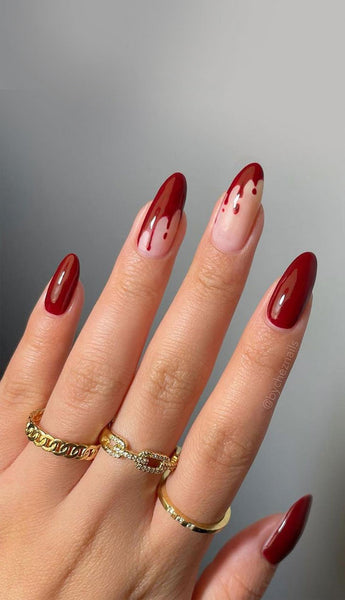 someones hand with fake blood nail art jack skellington super cool bright orange nail designs halloween nails halloween nails