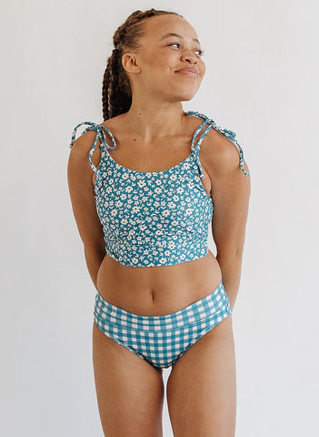 A woman wearing patterned nursing friendly swimwear