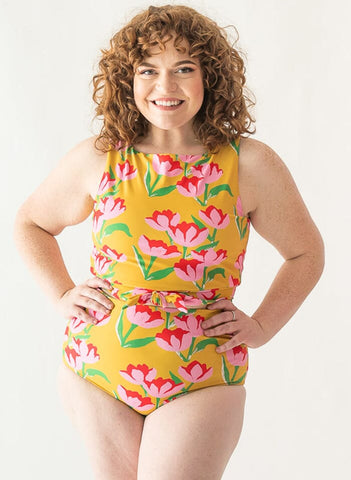 Photo of a woman wearing a Claus/Tage reversible swim bottom Claus side and a Claus swim crop top