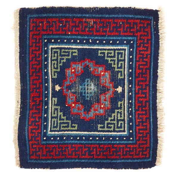 wool mat with blue red and yellow design embroidery