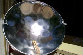 large inverted steel drum with stick placed inside