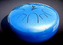 blue shiny circle tongue drum gray background