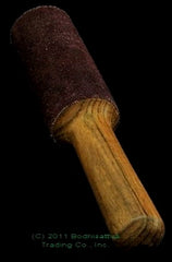 wooden mallet with black suede cover black background