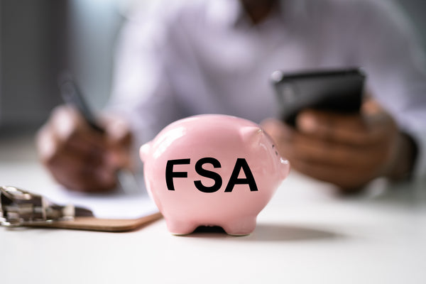 Pink piggy bank with the letters FSA printed on it