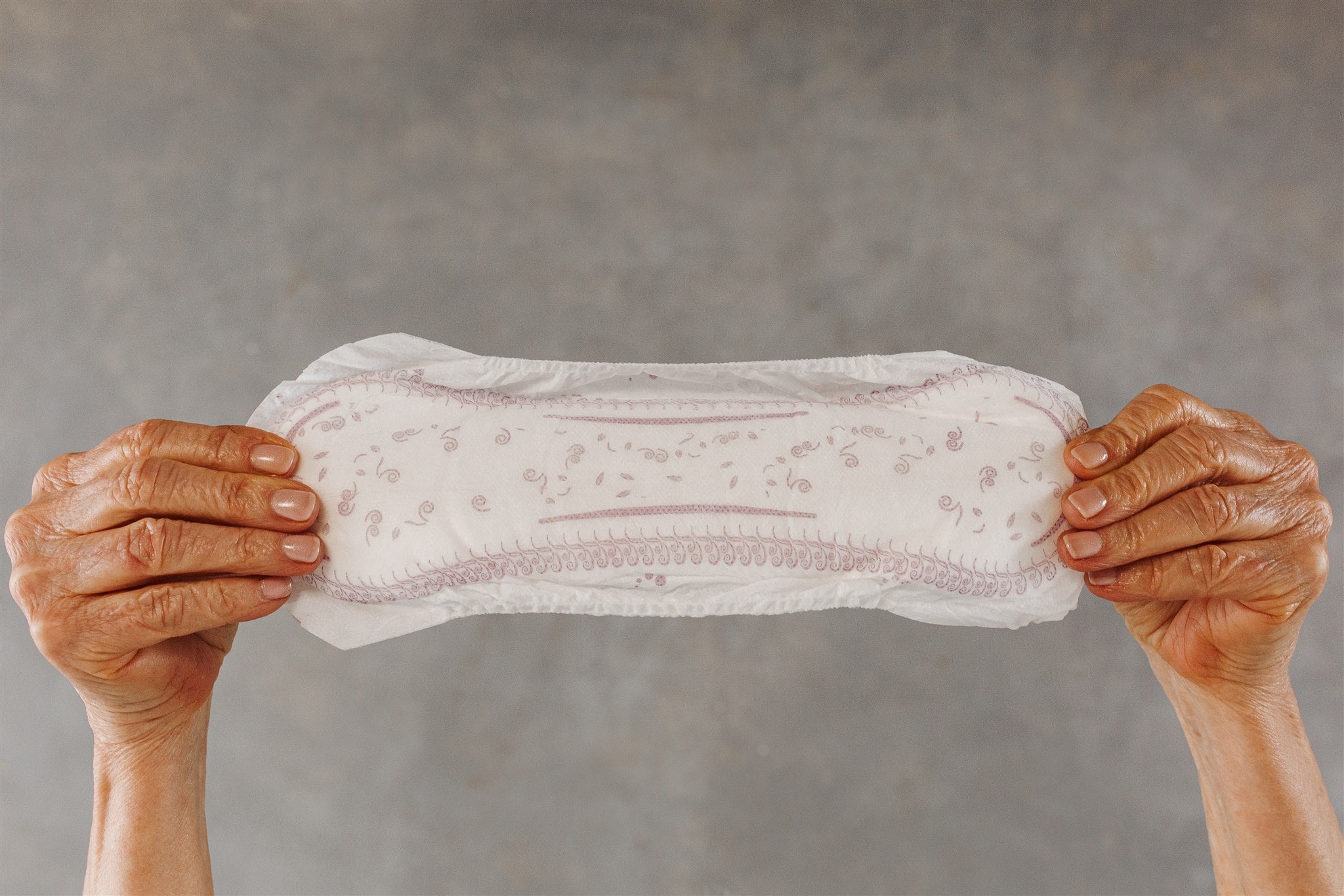 Woman holding an incontinence pad