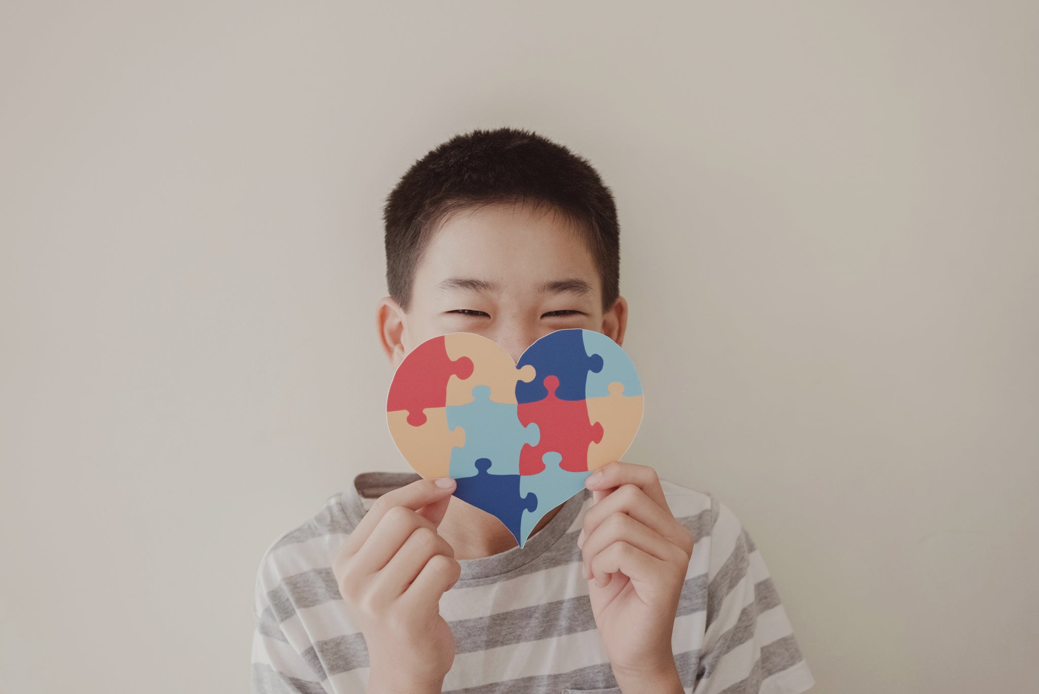 Boy holding heart shaped puzzlze