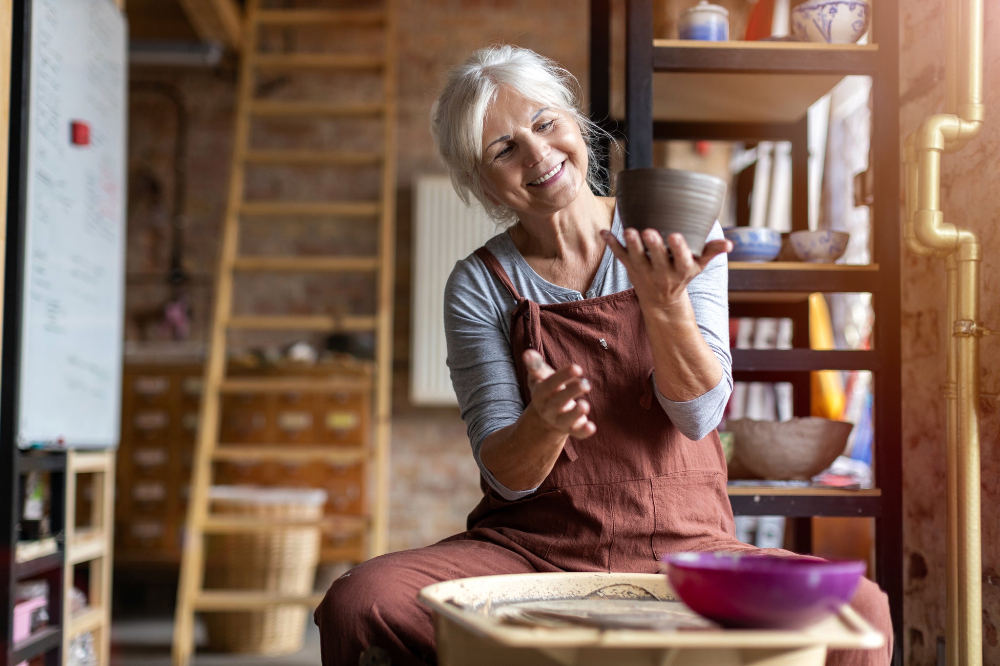 Woman at a pottery wheel making clay art