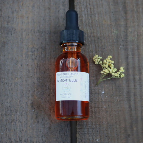 facial serum in amber glass bottle immortelle