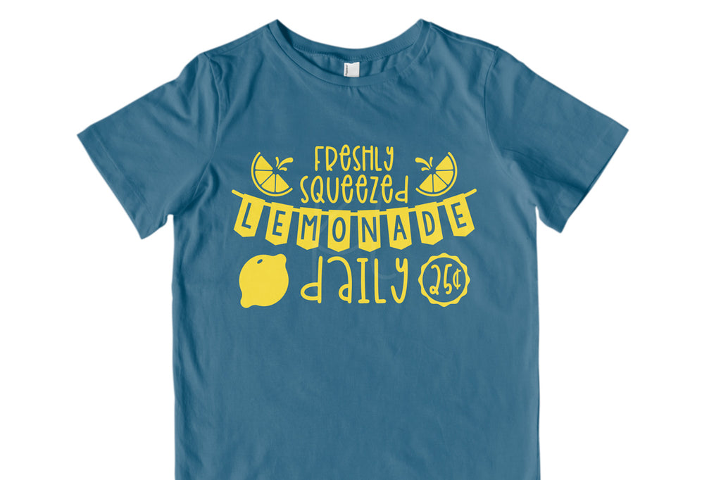 Children's blue shirt with the Lemonade Stand svg cut file in yellow