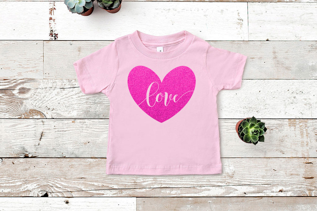 Love heart svg cut file in glitter on a toddler shirt