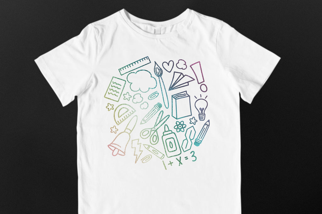 Child's white shirt with the School Doodle Cloud svg cut file in holographic vinyl