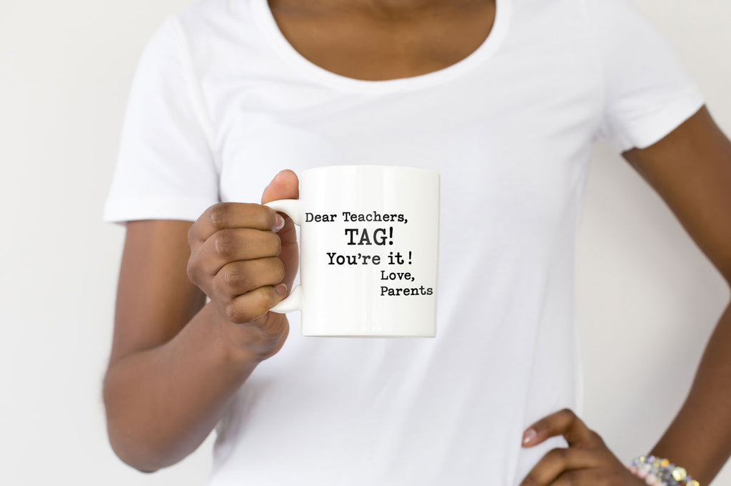 Woman holding a mug with the Dear Teachers, Tag! You're It! Love Parents svg cut file