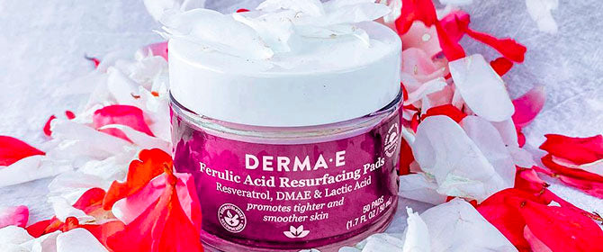 Ferulic Acide Pads by Derma E close up next to flowers