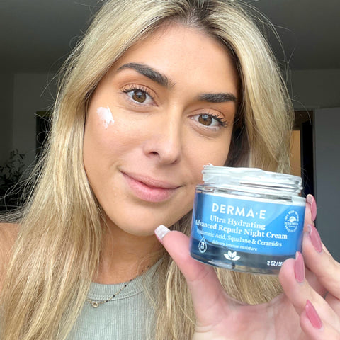 Olivia holds up a blue glass jar of DERMA E ultra hydrating night cream