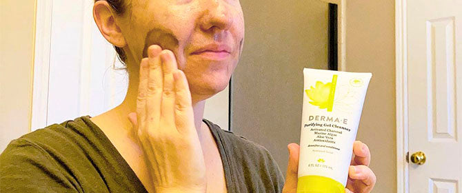 Person applying Seaweed Cleanser by Derma E