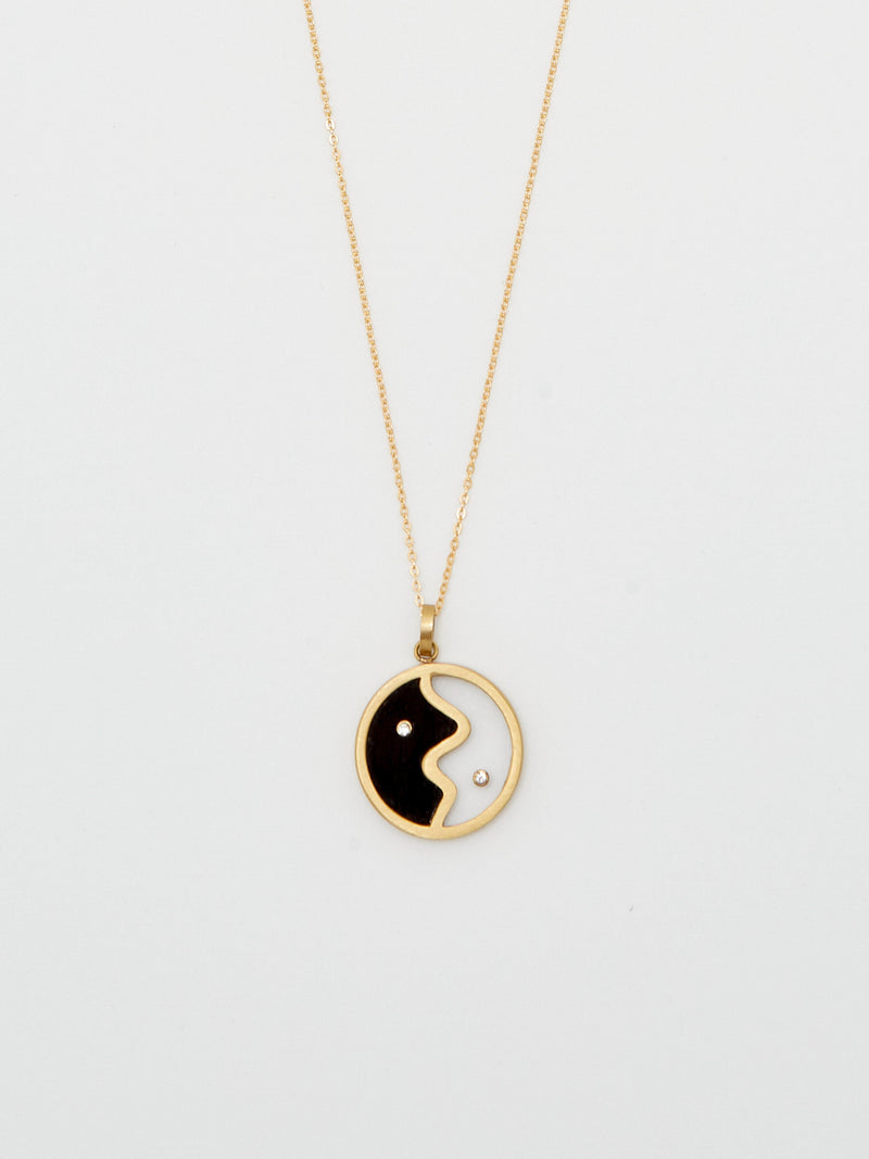 Cropped flat lay of the Yin Yang Glass Necklace Necklace bagatiba 