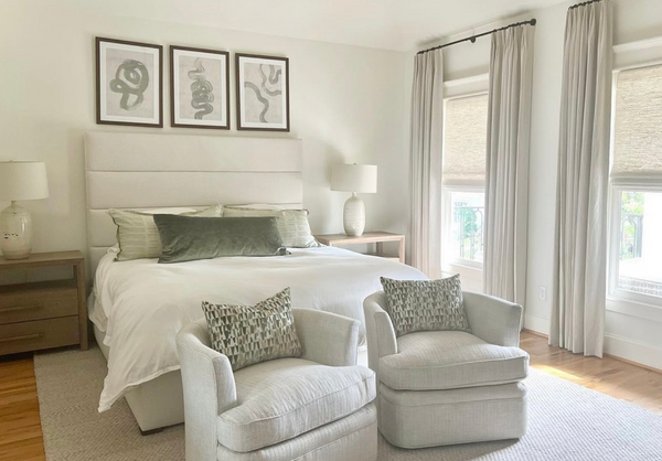 Beautiful bedroom with revolution fabrics on headboard and swivel chairs.