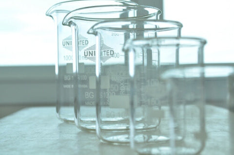 Pretty empty glass measure beakers lined up for making goat milk lotions
