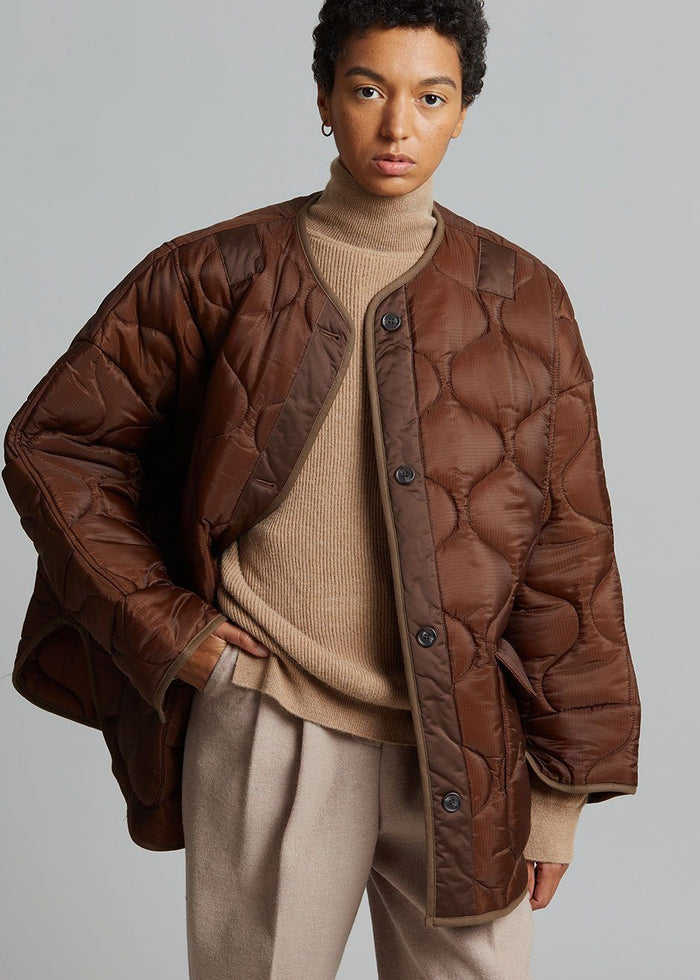 https://cdn.shopify.com/s/files/1/1527/0993/products/teddy-quilted-jacket-chocolate-jacket-the-frankie-shop-581679_700x.jpg?v=1629631499