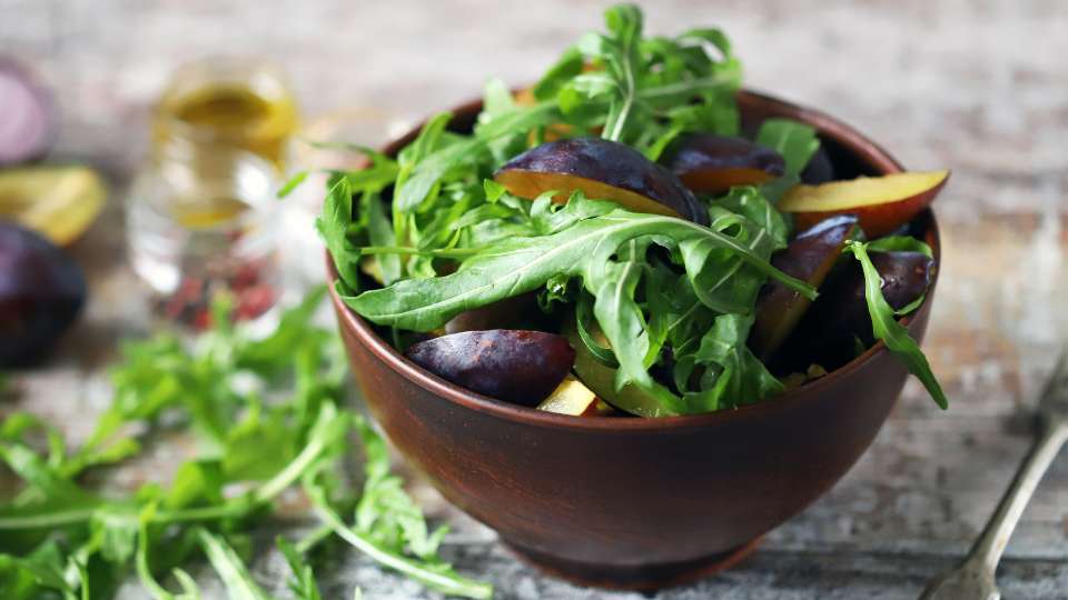 plum salad with arugala and plum shrub dressing