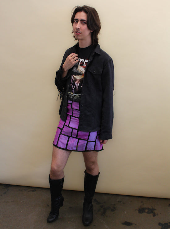 Non-binary person wears a vintage Led Zeplin t-shirt and purple patterned silk skirt