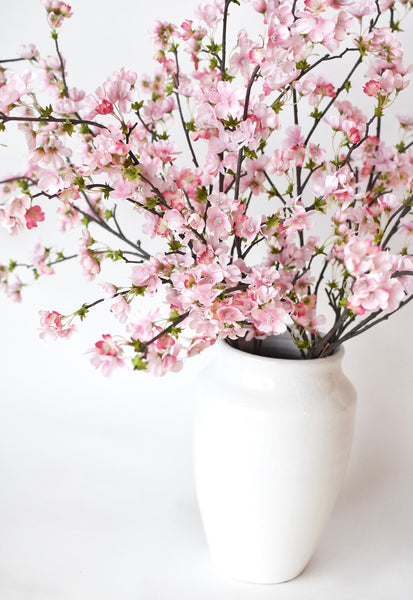 Faux quince stems fluffed for spring decor floral arrangement