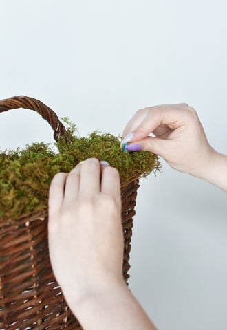 pinning moss on to floral foam to make floral arrangement diy how to faux flower