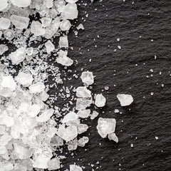 Close-up of sea salt crystals on stone slate