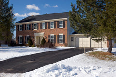 House in snow with clean driveway