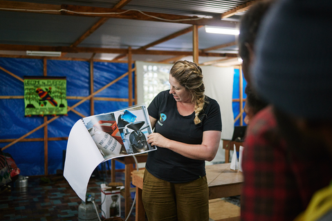 Nadia showing pictures of Kōkako roastery in Purosa, PNG