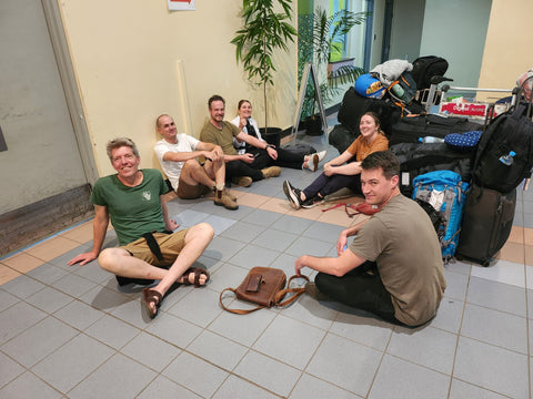 Fairtrade group sat on the ground at Port Moresby airport
