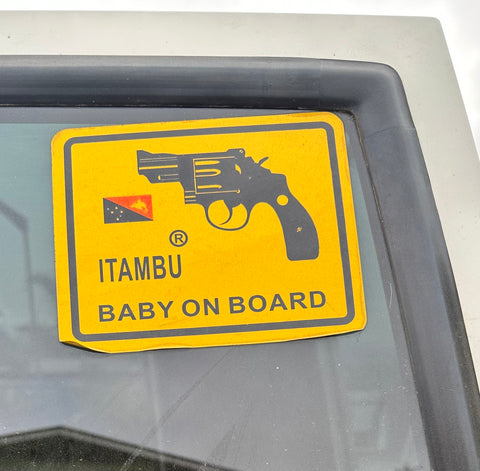 Sign on back of car – baby on board with a picture of a gun