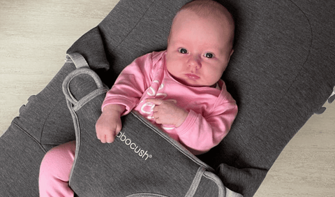 Newborn baby girl on Babocush Bouncer wearing pink