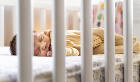 Newborn baby in crib 