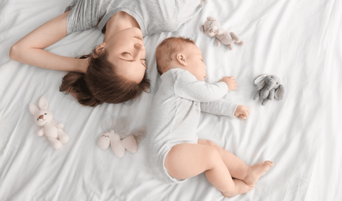Mother sleeping with baby