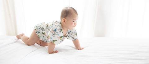 Baby crawling on bed