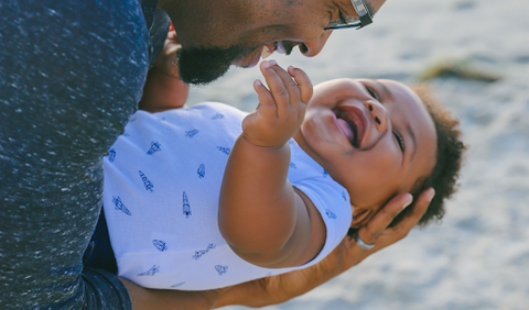 smiling baby and father