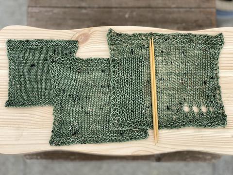 Three swatches of a green tweedy yarn