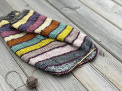 A striped knitted cowl project in progress on circular needles