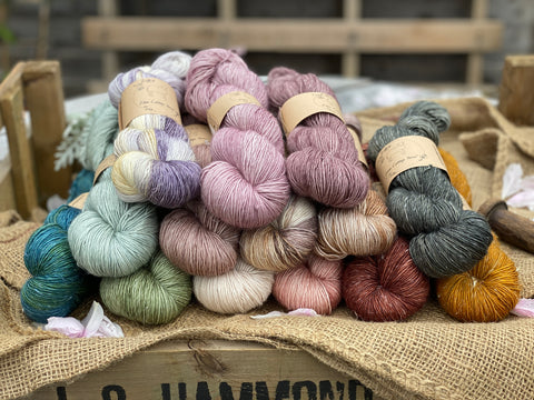 A pile of yarn skeins in various colours