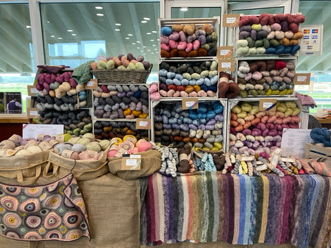 a table with boxes of hand dyed yarn on it