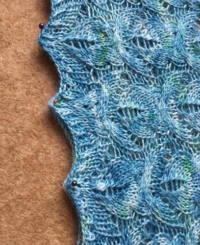 closeup of knitted lace in a turquoise yarn