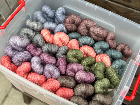 A box full of skeins of hand dyed yarn
