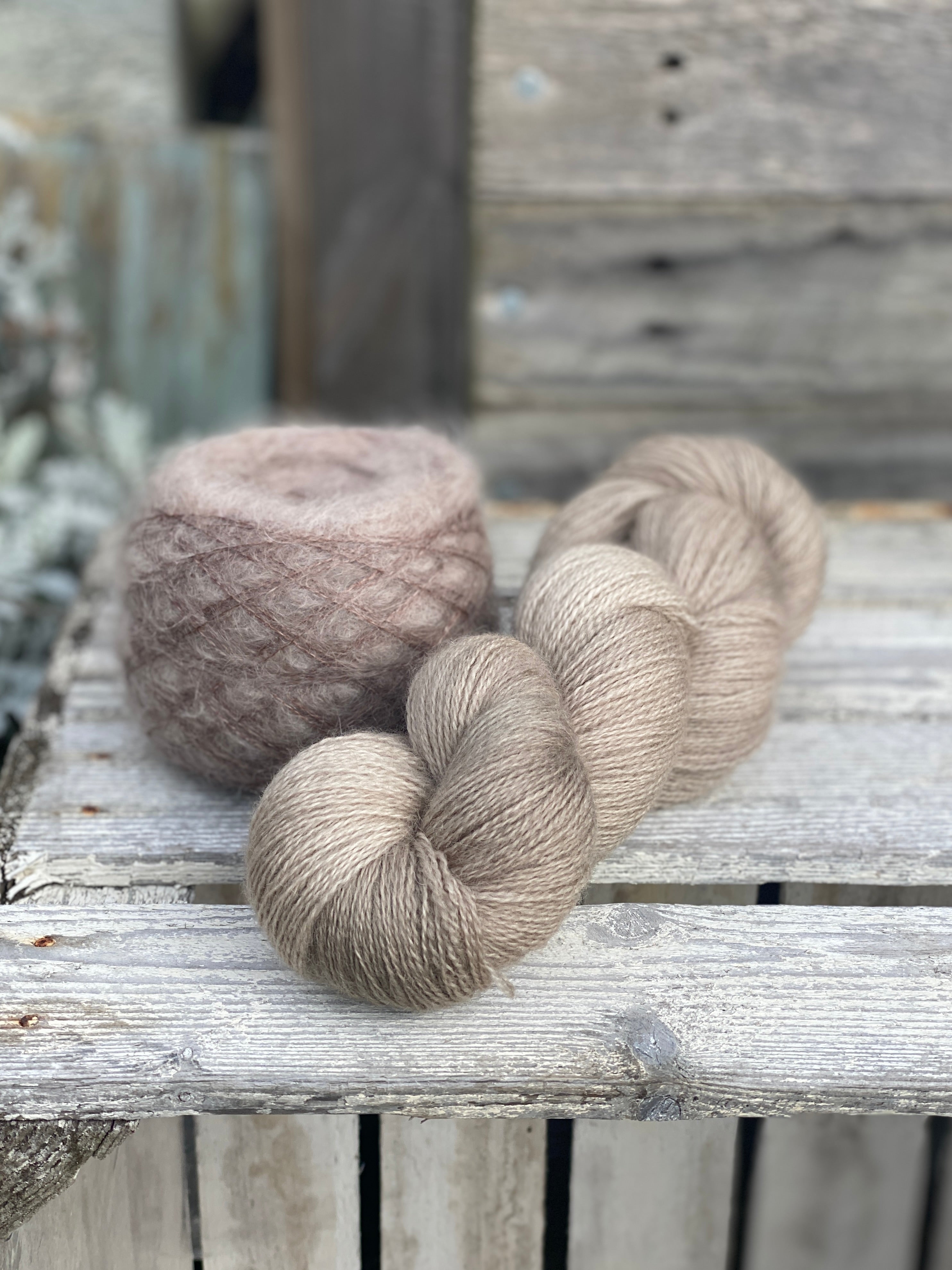 One skein of light brown laceweight yarn and one cake of fluffy laceweight yarn also in light brown