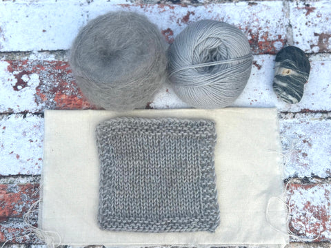 a silvery grey fluffy knitted swatch