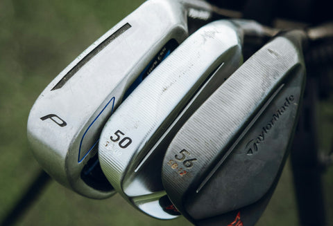 detail of the club heads of 3 demo golf clubs